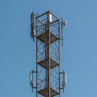 A telecommunications tower with antennas, used for transmitting signals and supporting communication networks.