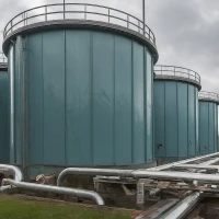 Storage tanks at a wastewater treatment plant, used for processing and storing treated water.