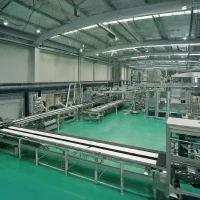 An industrial warehouse featuring automated manufacturing machinery powered by various electrical components.